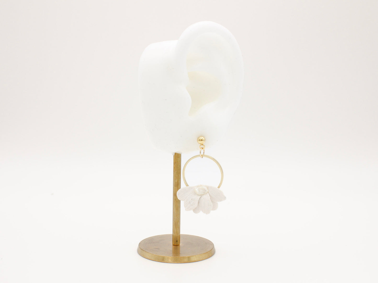 Handmade white petal hoop polymer clay earrings with gold stud posts.