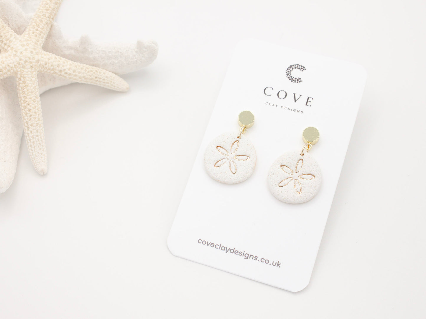 Handmade sand dollar polymer clay earrings with a delicate sand effect finish