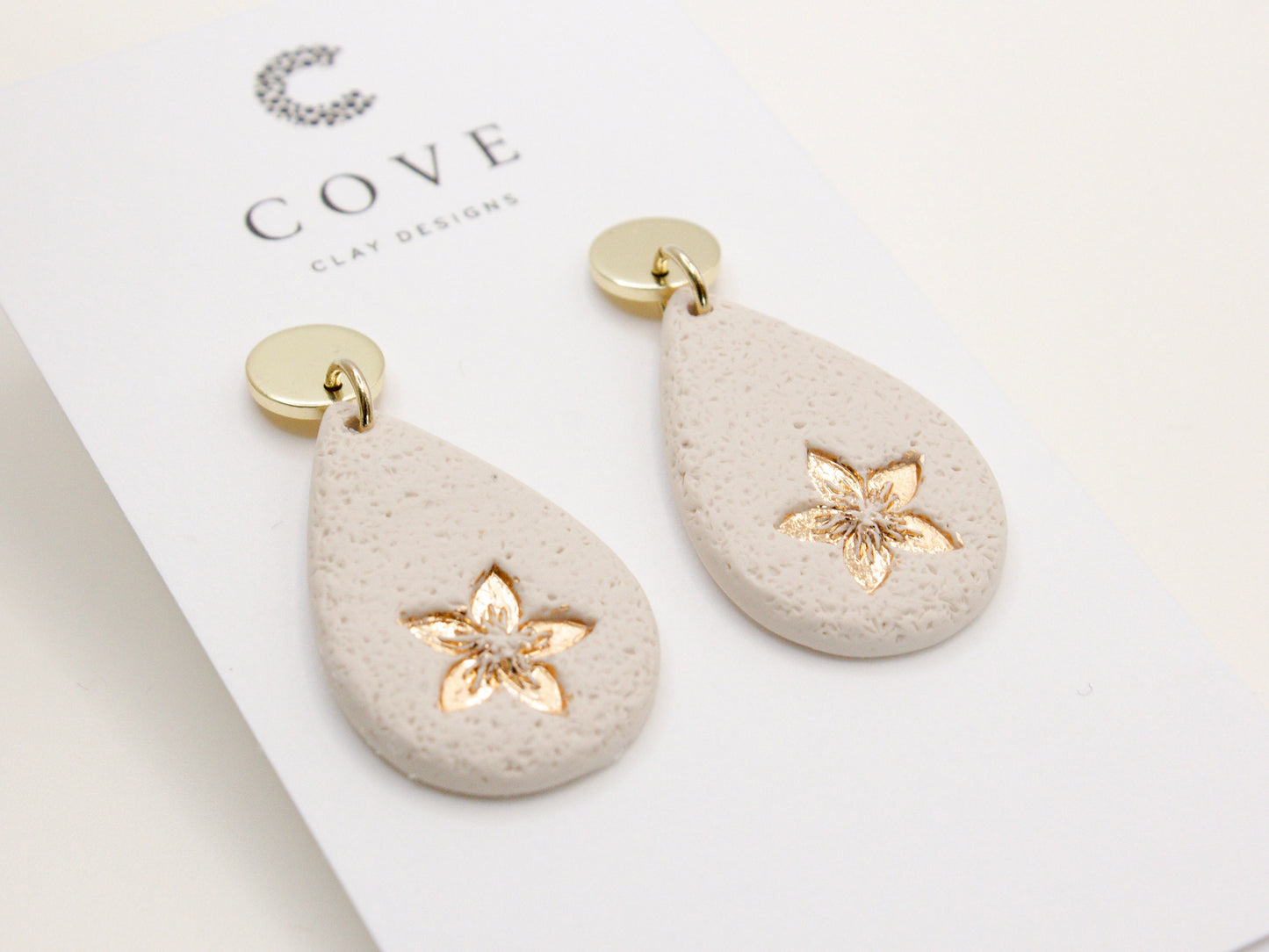 Handmade flower embossed teardrop clay earrings by Cove Clay Designs
