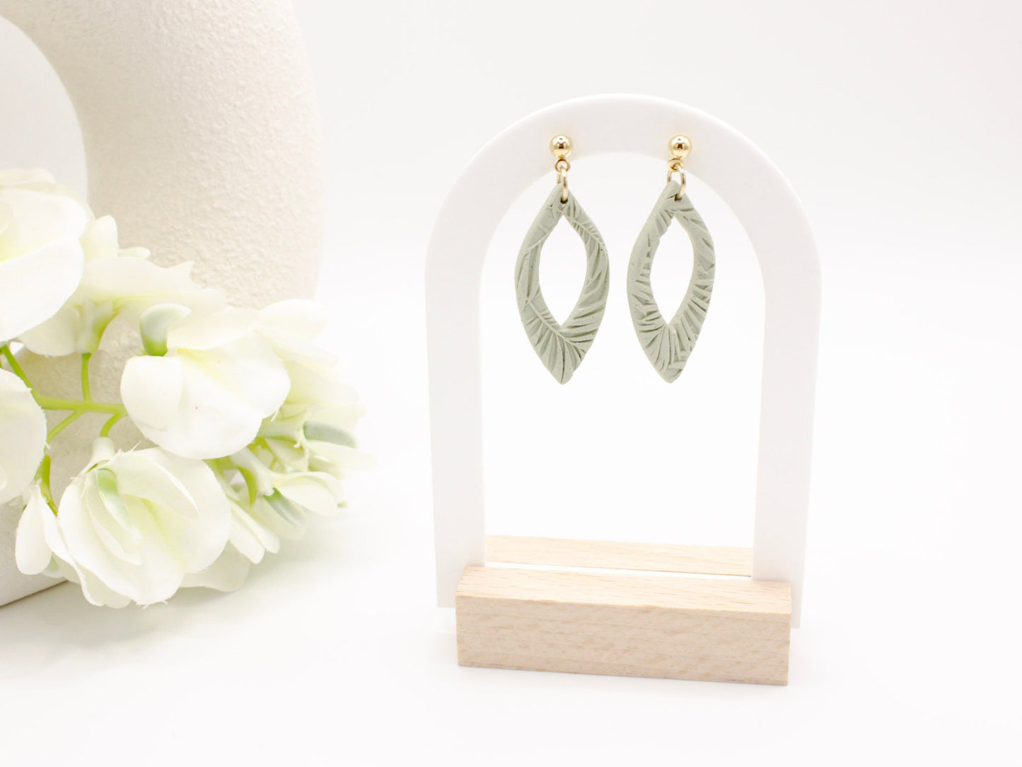 Handmade green tropical leaf print clay dangle earrings by Cove Clay Designs