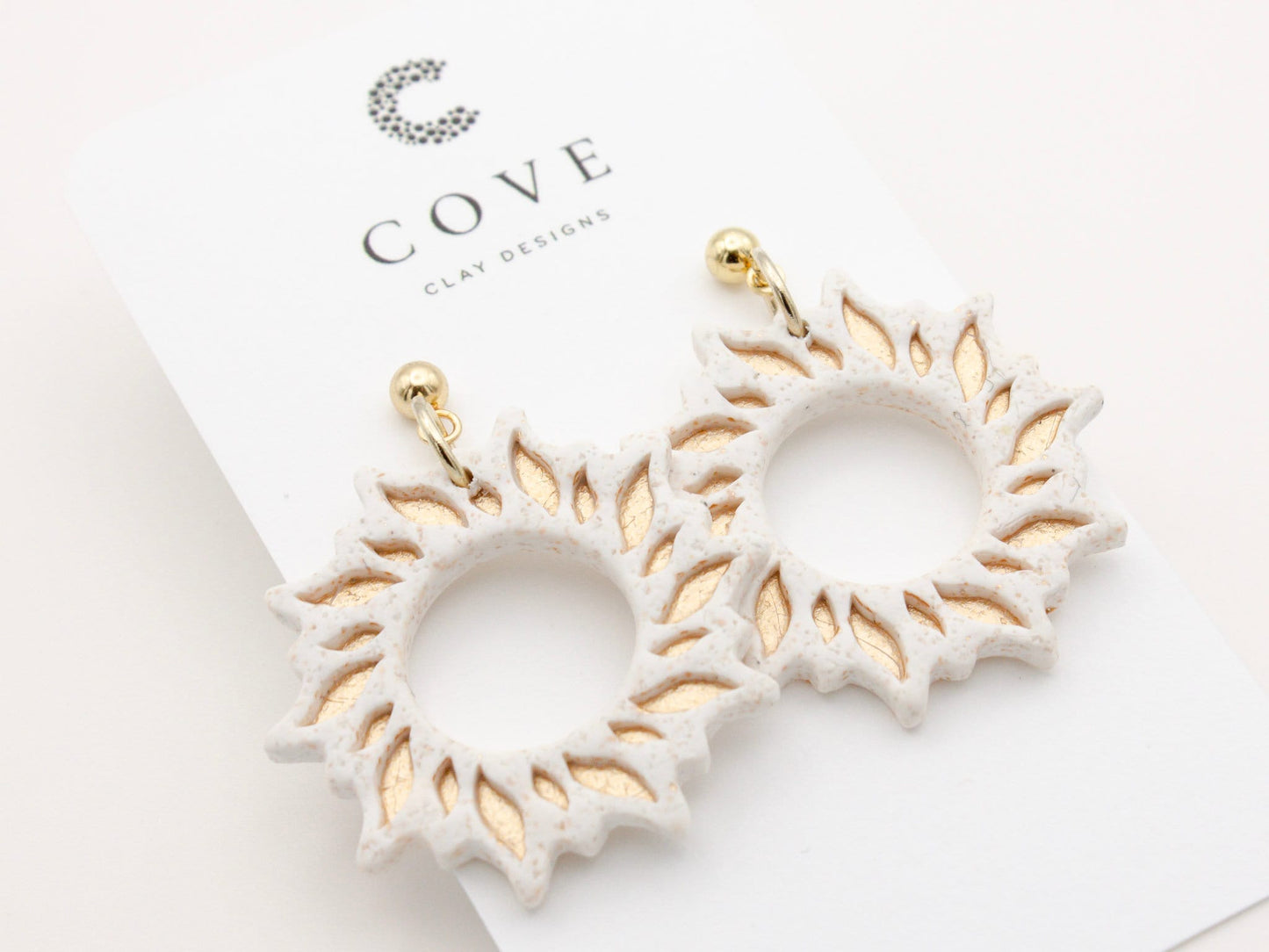 Handmade gold sun dangle clay earrings with gold posts by Cove Clay Designs