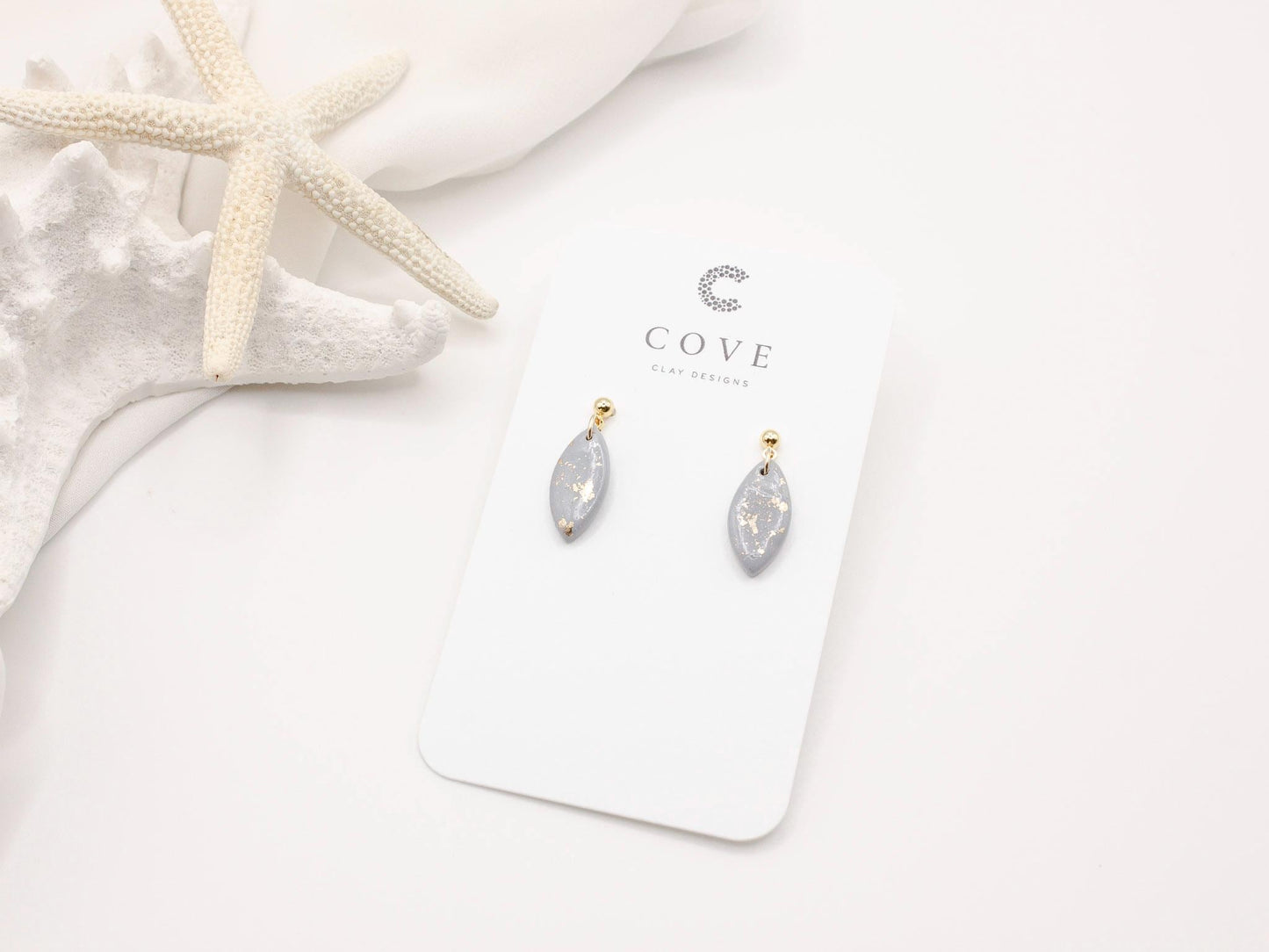 Handmade mini dusty blue and speckled gold little drop polymer clay earrings by Cove Clay Designs