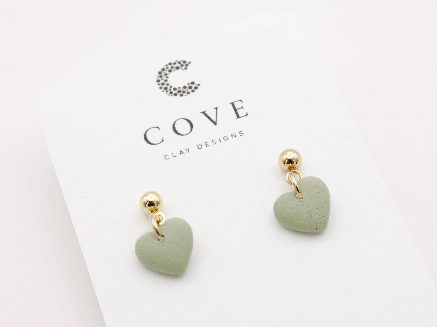 Handmade mini green heart polymer clay earrings with gold posts by Cove Clay Designs