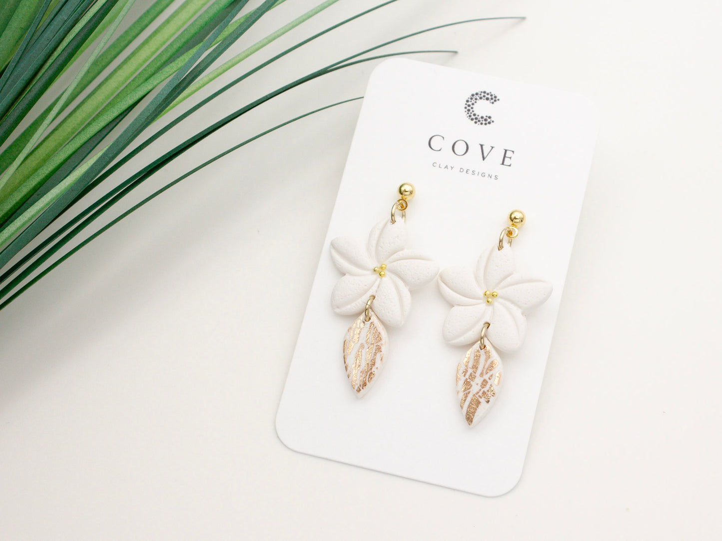 Handmade white plumeria tropical flower clay earrings by Cove Clay Designs