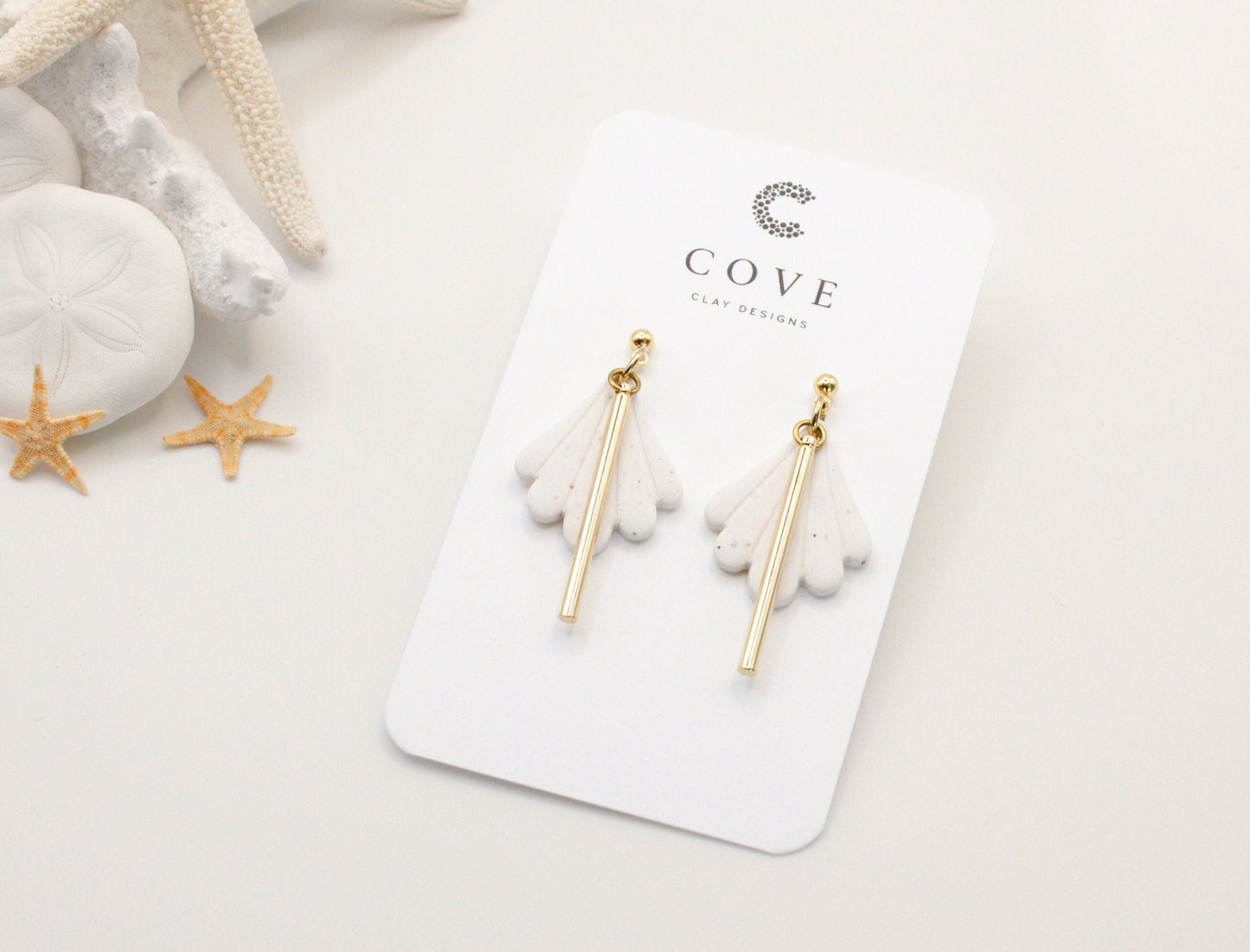 Handmade white fan scallop shell clay earrings with gold posts.