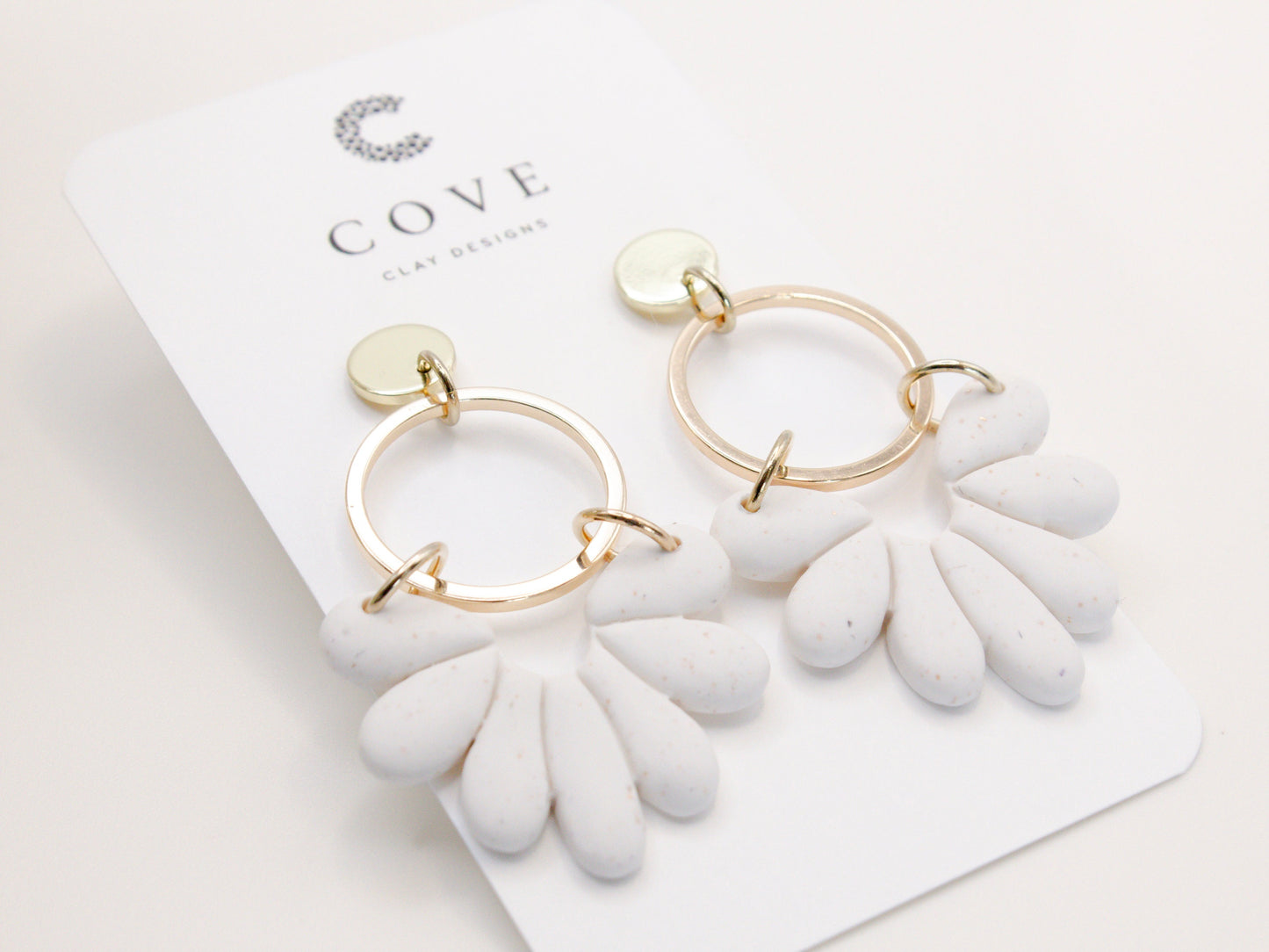 Handmade white sand effect scallop shell hoop dangle clay earrings with gold posts and round connectors by Cove Clay Designs