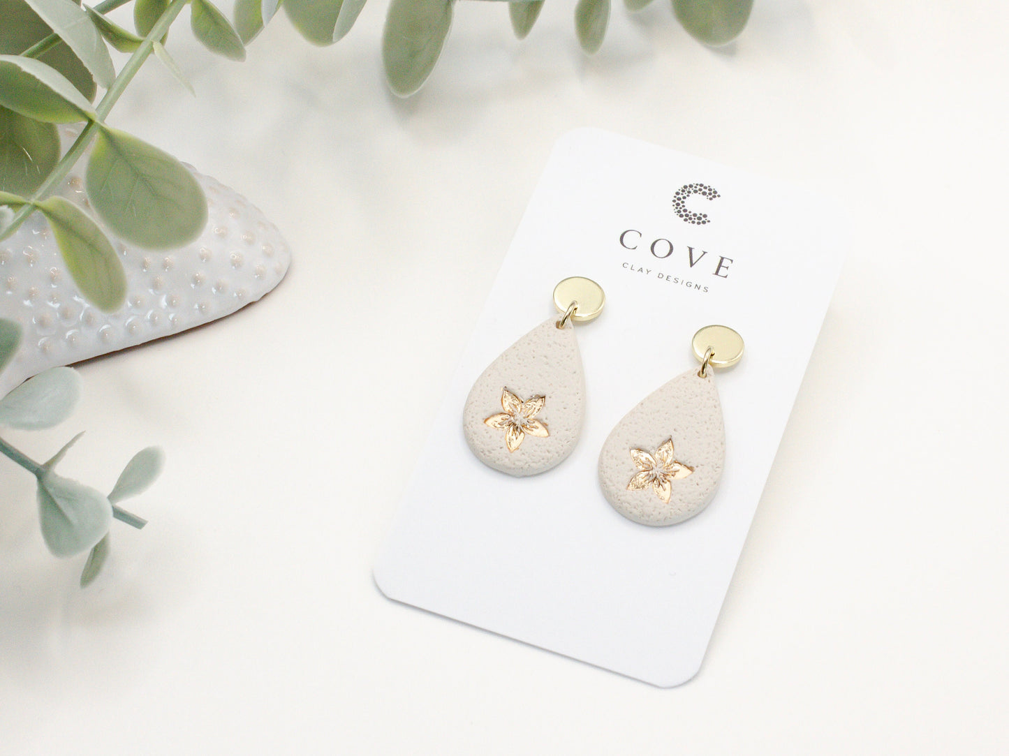 Handmade flower embossed teardrop clay earrings by Cove Clay Designs