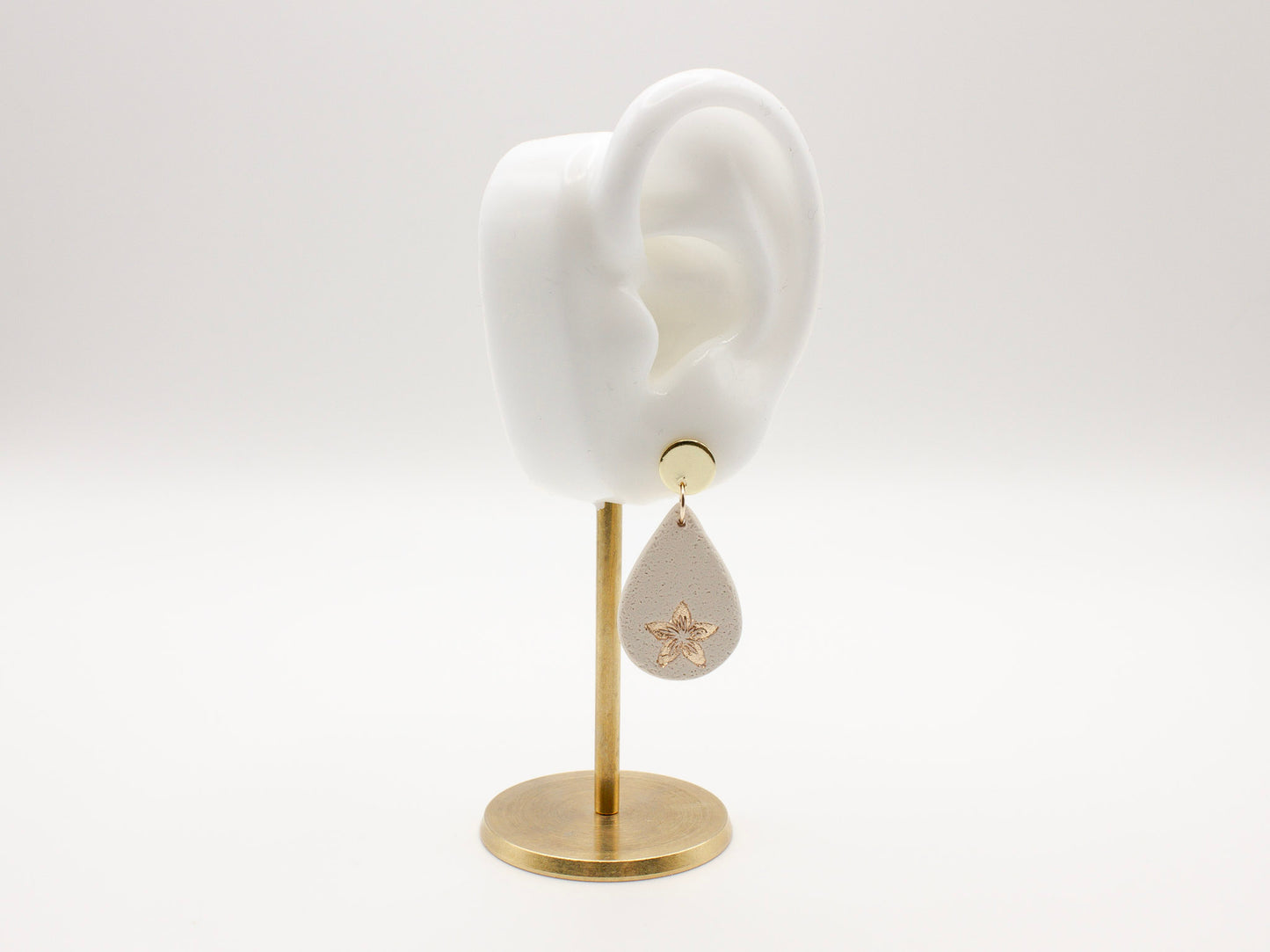 Handmade flower embossed teardrop clay earrings by Cove Clay Designs