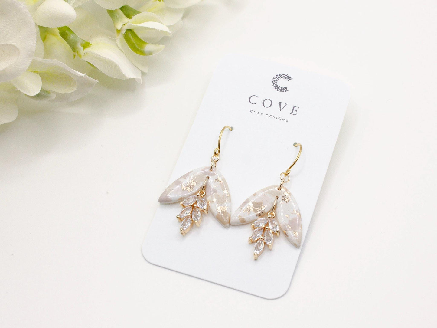 Handmade terrazzo leaf dangle clay earrings with gold hooks and cubic zirconia charms by Cove Clay Designs