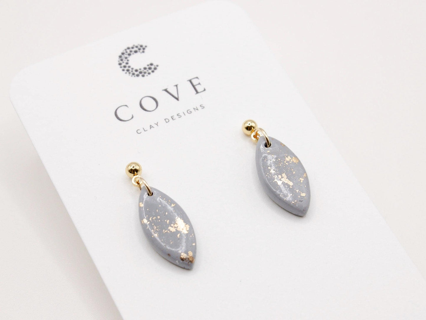Handmade mini dusty blue and speckled gold little drop polymer clay earrings by Cove Clay Designs