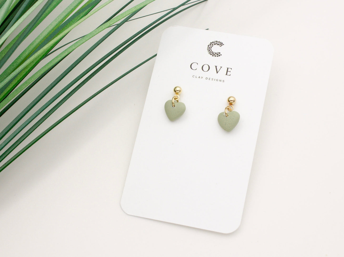 Handmade mini green heart polymer clay earrings with gold posts by Cove Clay Designs