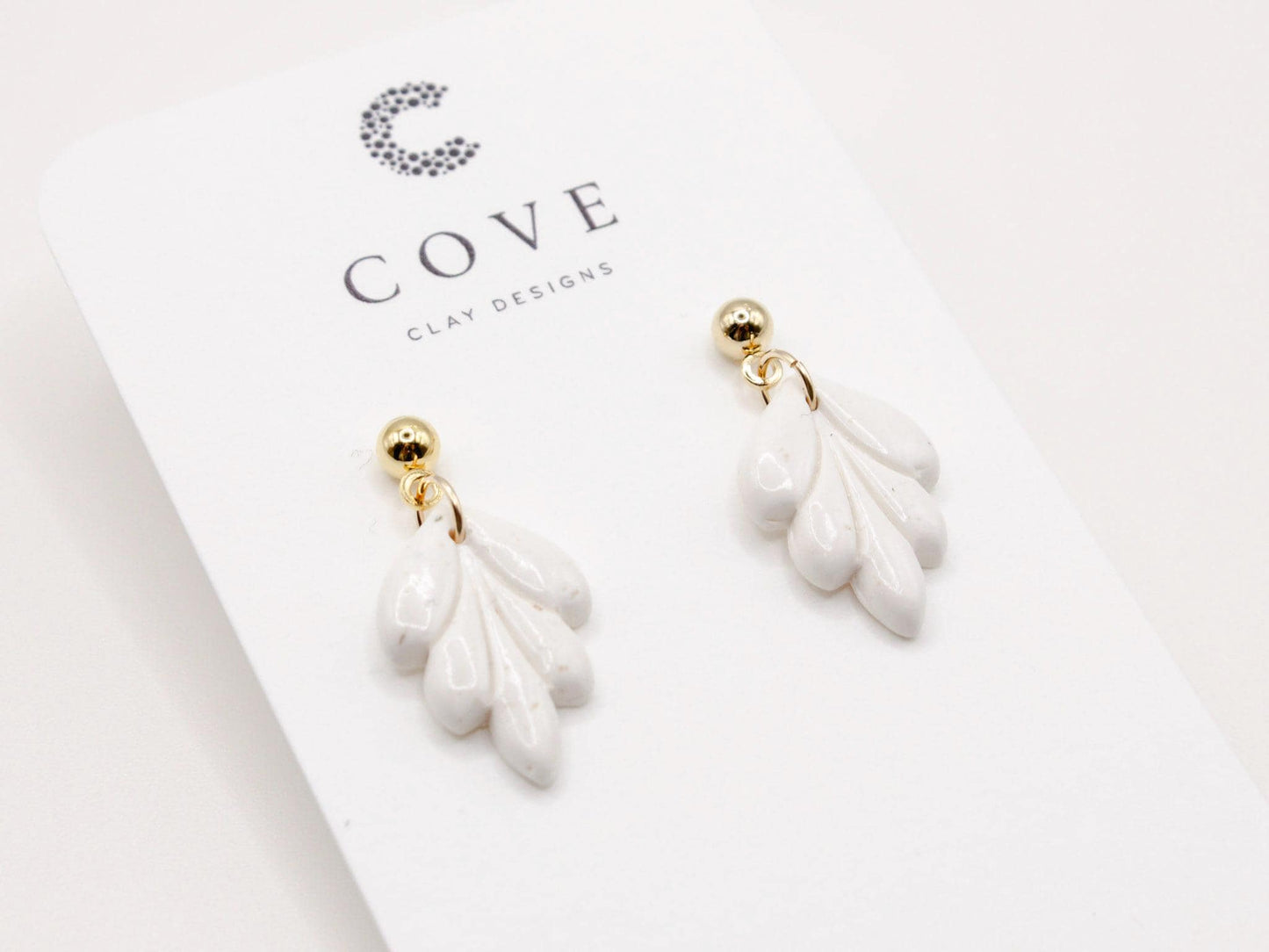 Handmade mini white leaf polymer clay earrings by Cove Clay Designs