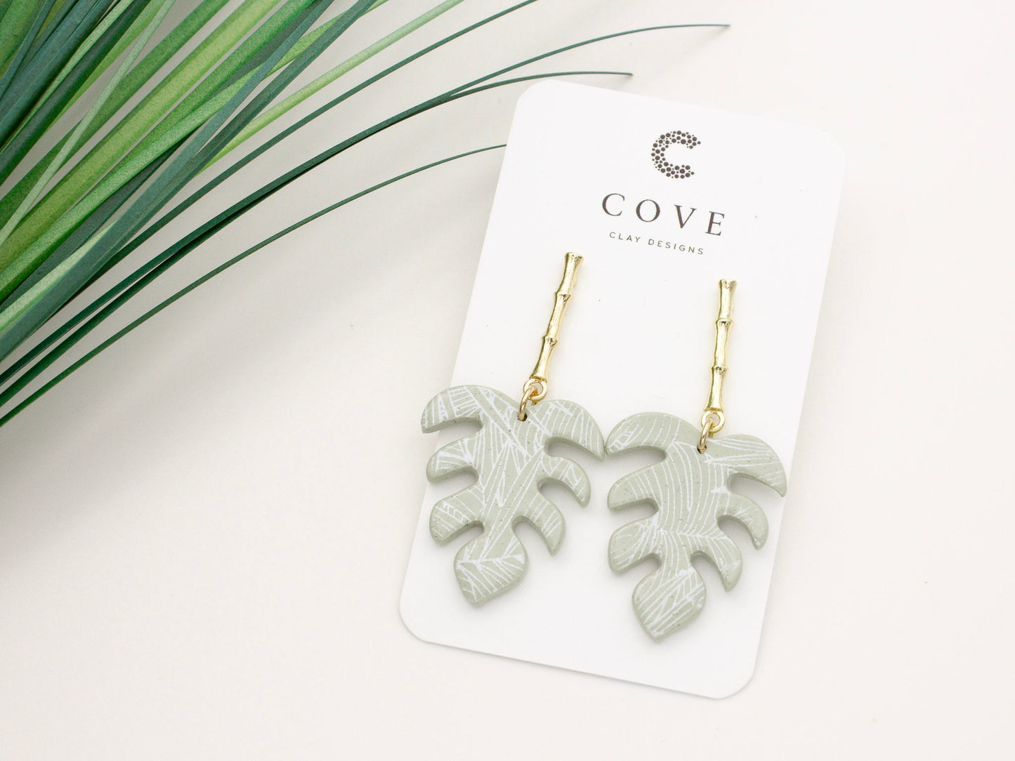 Handmade tropical green palm leaf clay earrings with gold posts by Cove Clay Designs