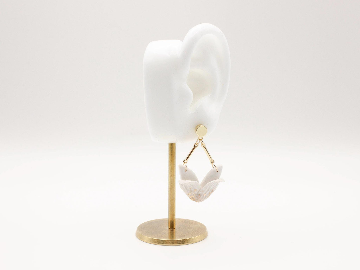 Handmade white tulip inspired clay dangle earrings with gold stud posts by Cove Clay Designs