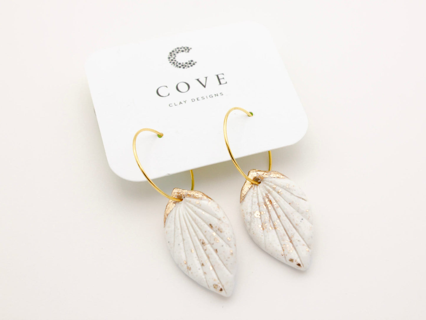 Handmade white and gold tropical leaf clay hoop earrings