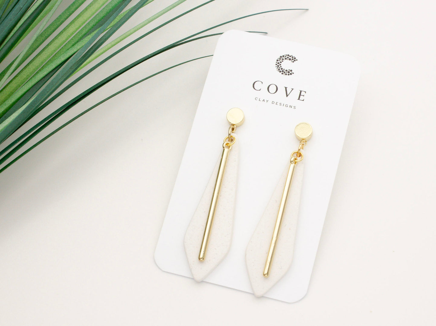Handmade long white clay dangle earrings with gold posts by Cove Clay Designs
