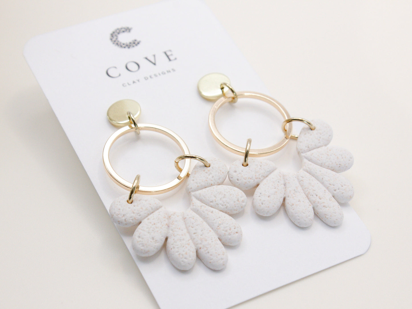 Handmade white sand effect scallop shell hoop dangle clay earrings with gold posts and round connectors by Cove Clay Designs
