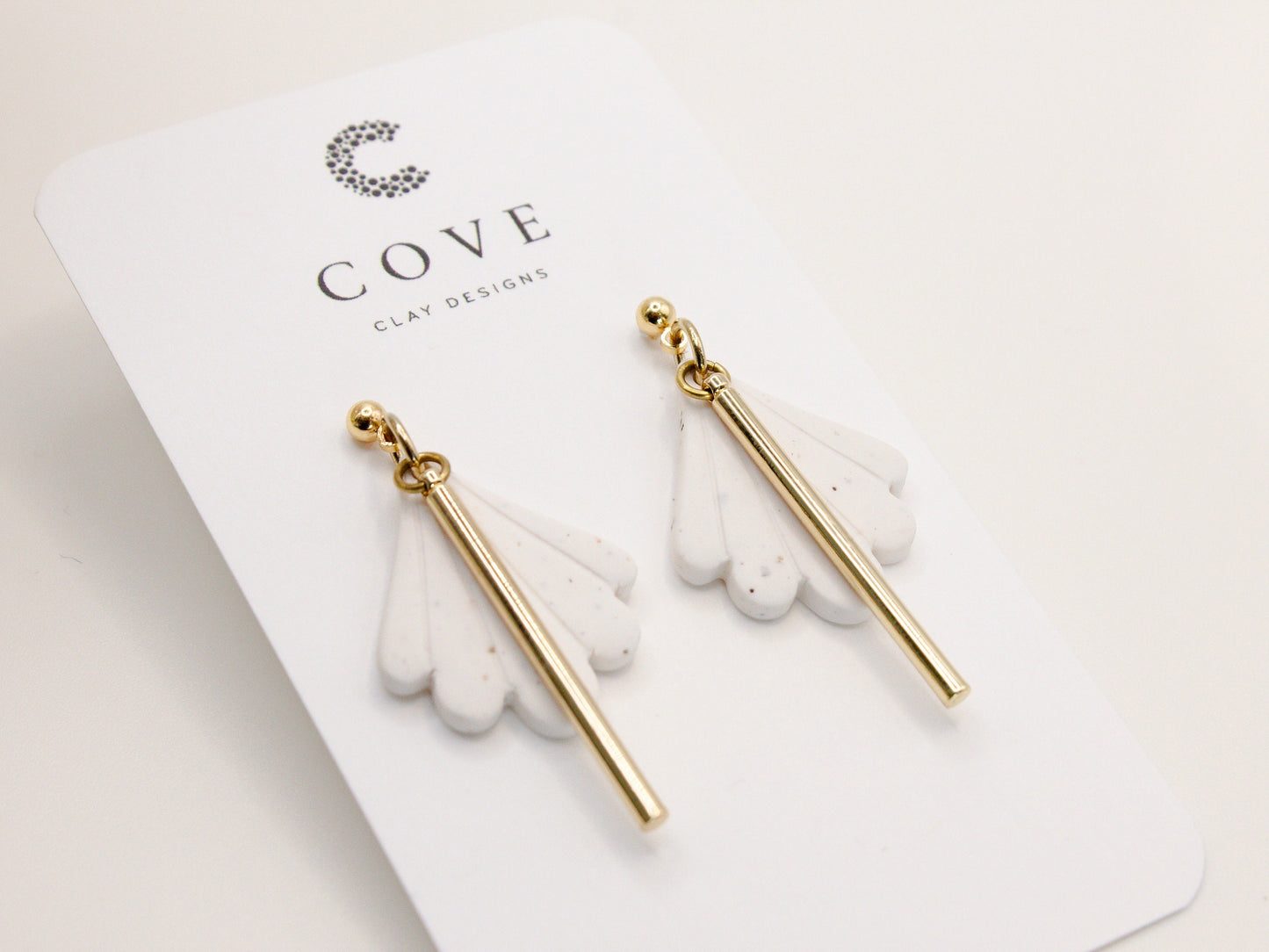 Handmade white fan scallop shell clay earrings with gold posts.
