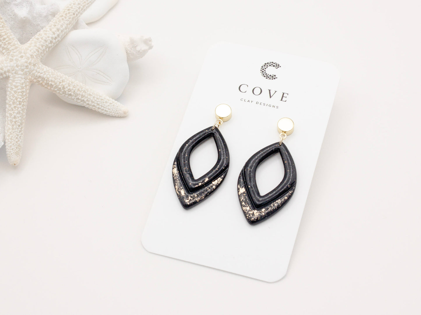 Handmade black and gold fleck double drop polymer clay earrings by Cove Clay Designs