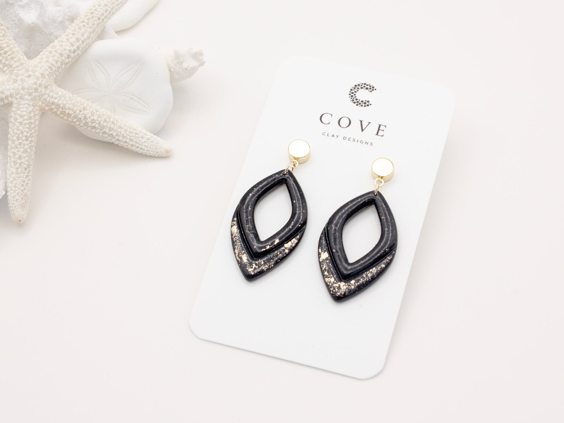 Handmade black and gold fleck double drop polymer clay earrings by Cove Clay Designs