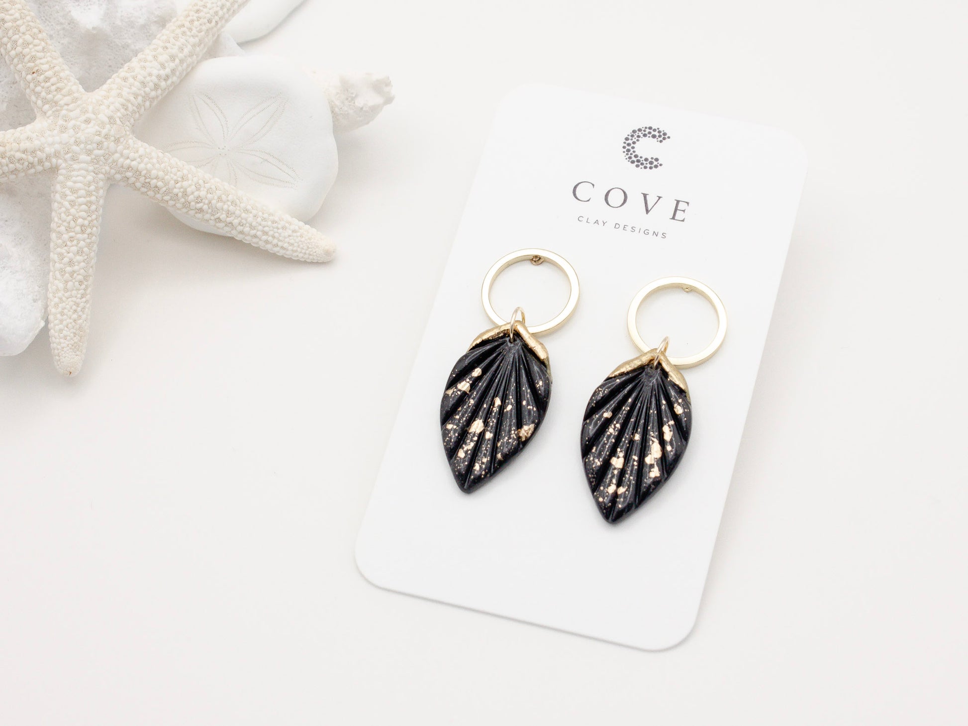 Handmade black and gold fleck fan hoop polymer clay earrings by Cove Clay Designs