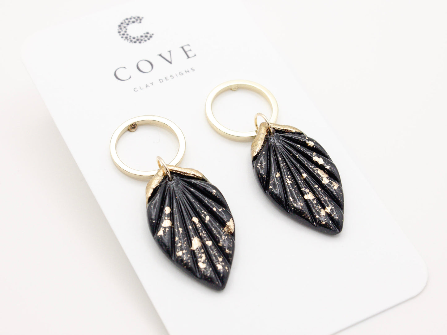 Handmade black and gold fleck fan hoop polymer clay earrings by Cove Clay Designs