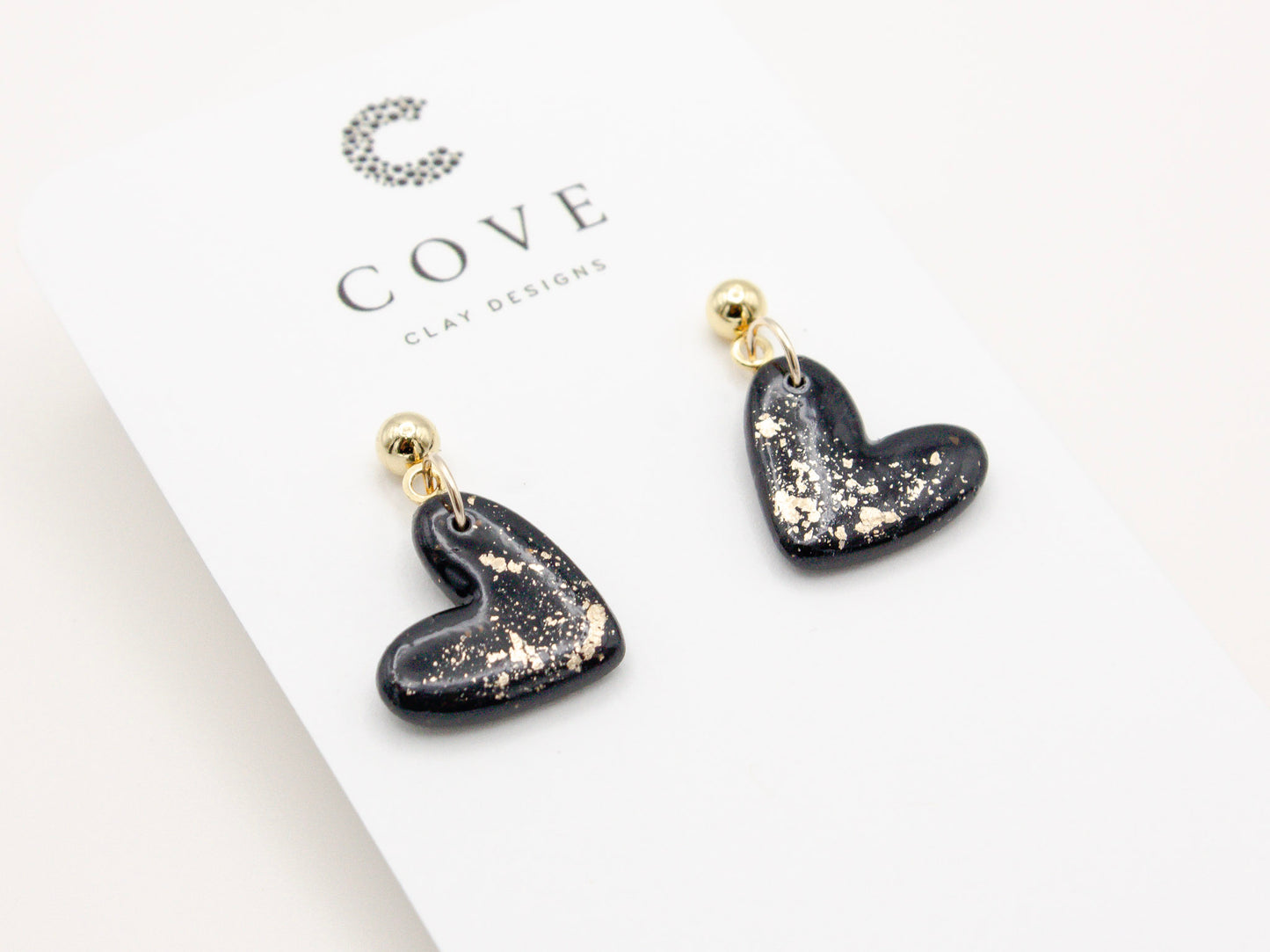 Handmade black and gold fleck mini heart polymer clay earrings by Cove Clay Designs