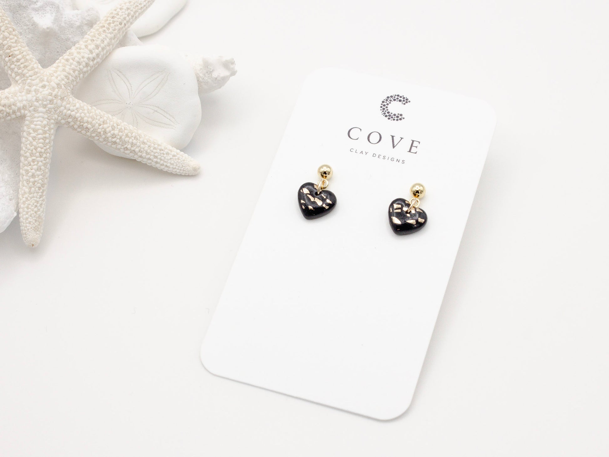 Handmade mini black and gold fleck heart polymer clay earrings by Cove Clay Designs