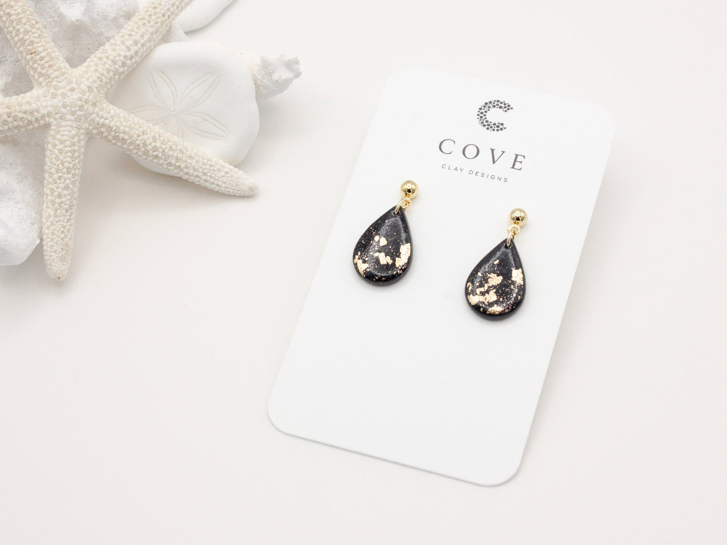 Handmade black and gold fleck mini teardrop polymer clay earrings by Cove Clay Designs