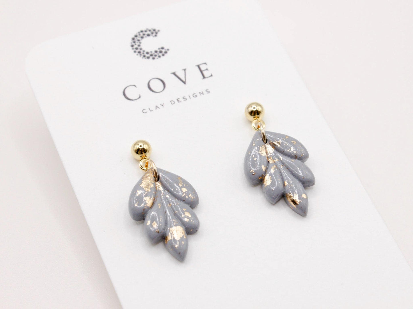 Handmade mini dusty blue and speckled gold leaf polymer clay earrings by Cove Clay Designs