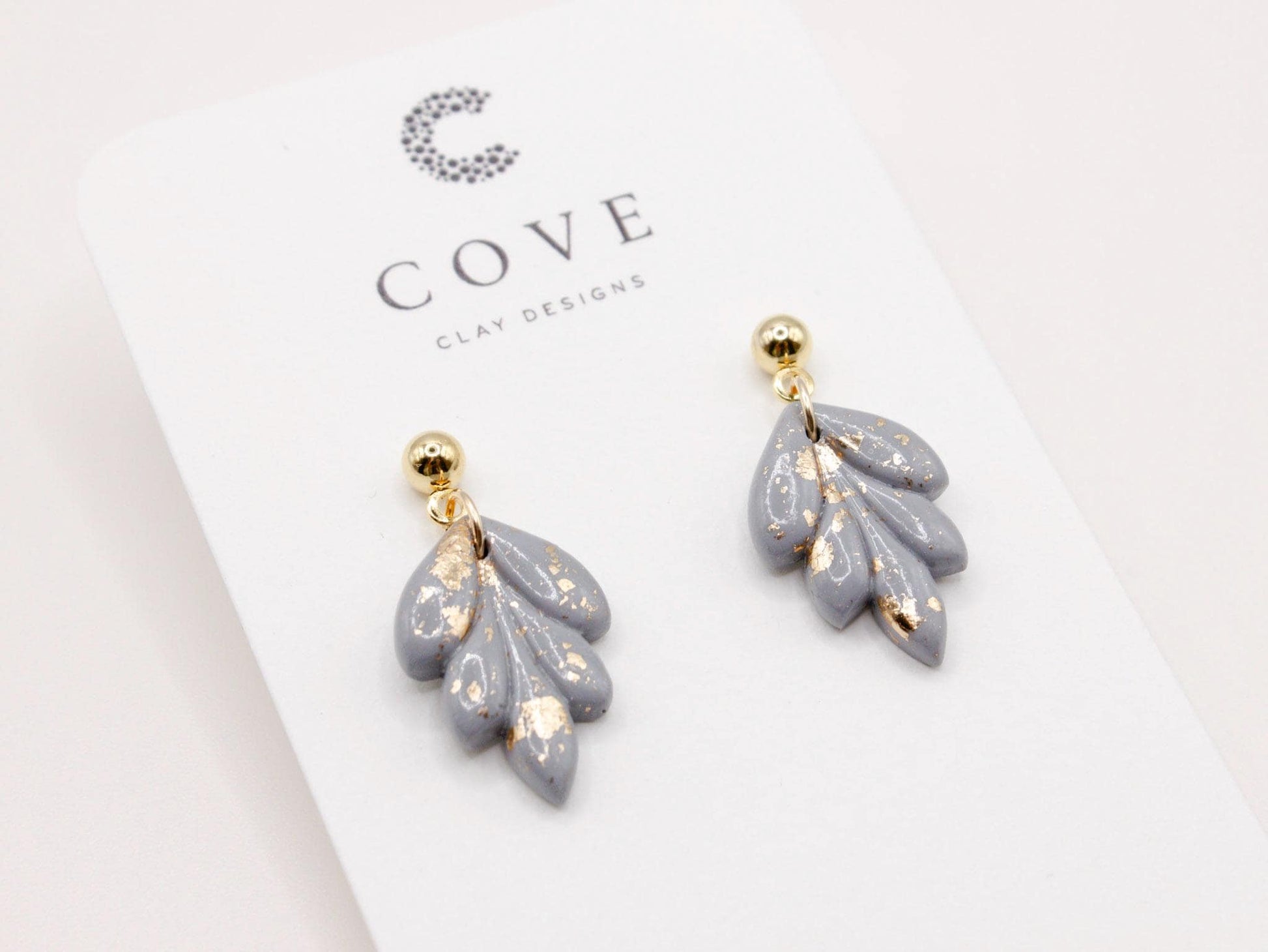 Handmade mini dusty blue and speckled gold leaf polymer clay earrings by Cove Clay Designs