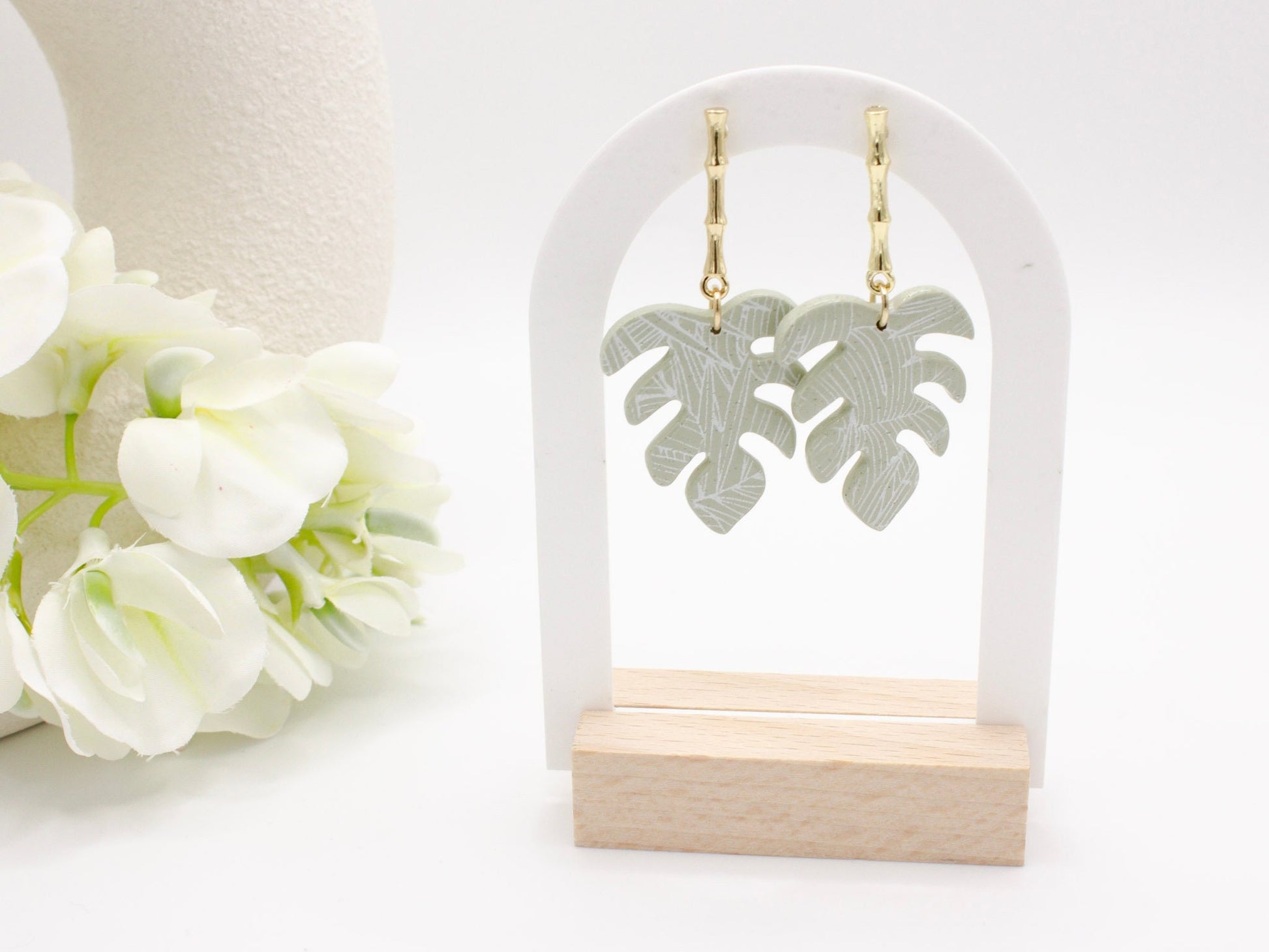 Handmade tropical green palm leaf clay earrings with gold posts by Cove Clay Designs