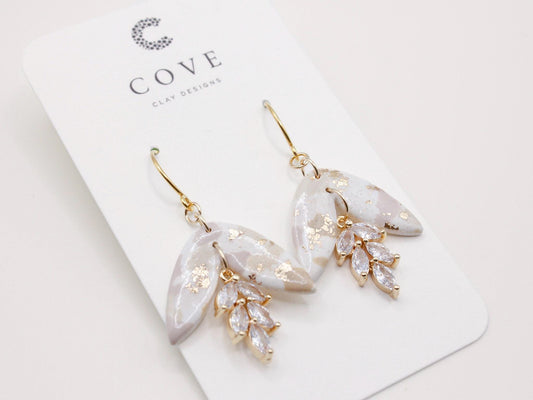 Handmade terrazzo leaf dangle clay earrings with gold hooks and cubic zirconia charms by Cove Clay Designs