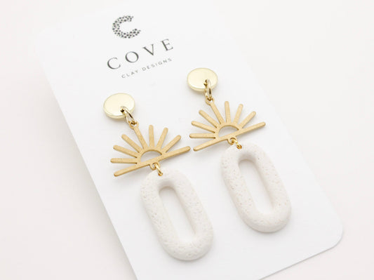 Handmade gold sun and white dangle polymer clay earrings by Cove Clay Designs