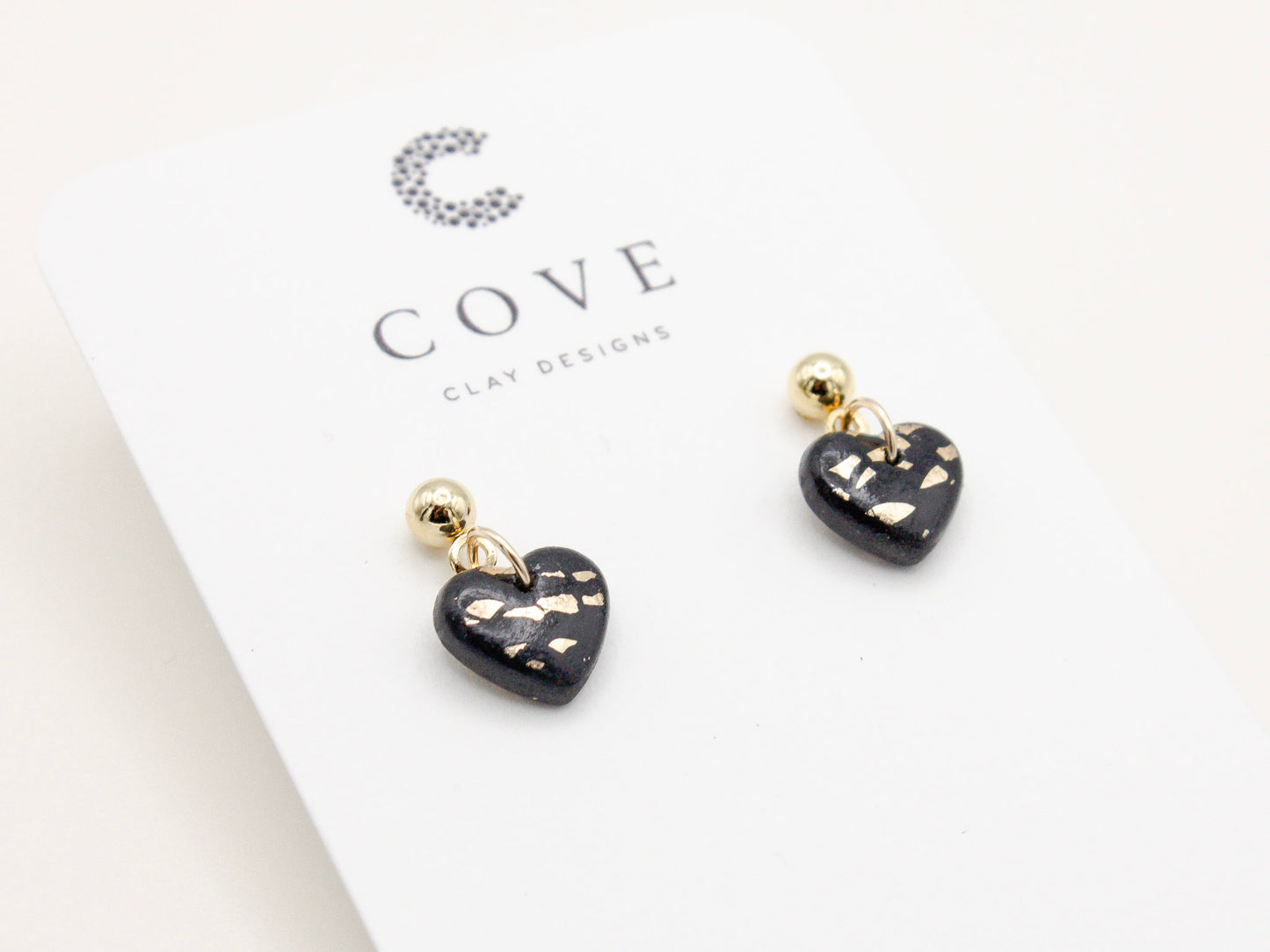 Handmade black and gold fleck mini heart polymer clay earrings by Cove Clay Designs