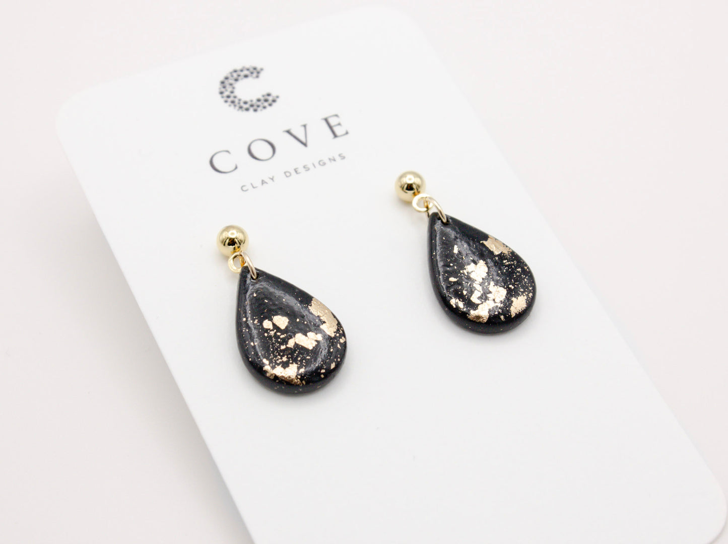 Handmade black and gold fleck mini teardrop polymer clay earrings by Cove Clay Designs