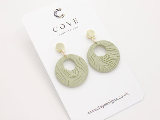 Handmade Round Green Swirl Polymer Clay Earrings for Women by Cove. Perfect for your beach and summer outfits.