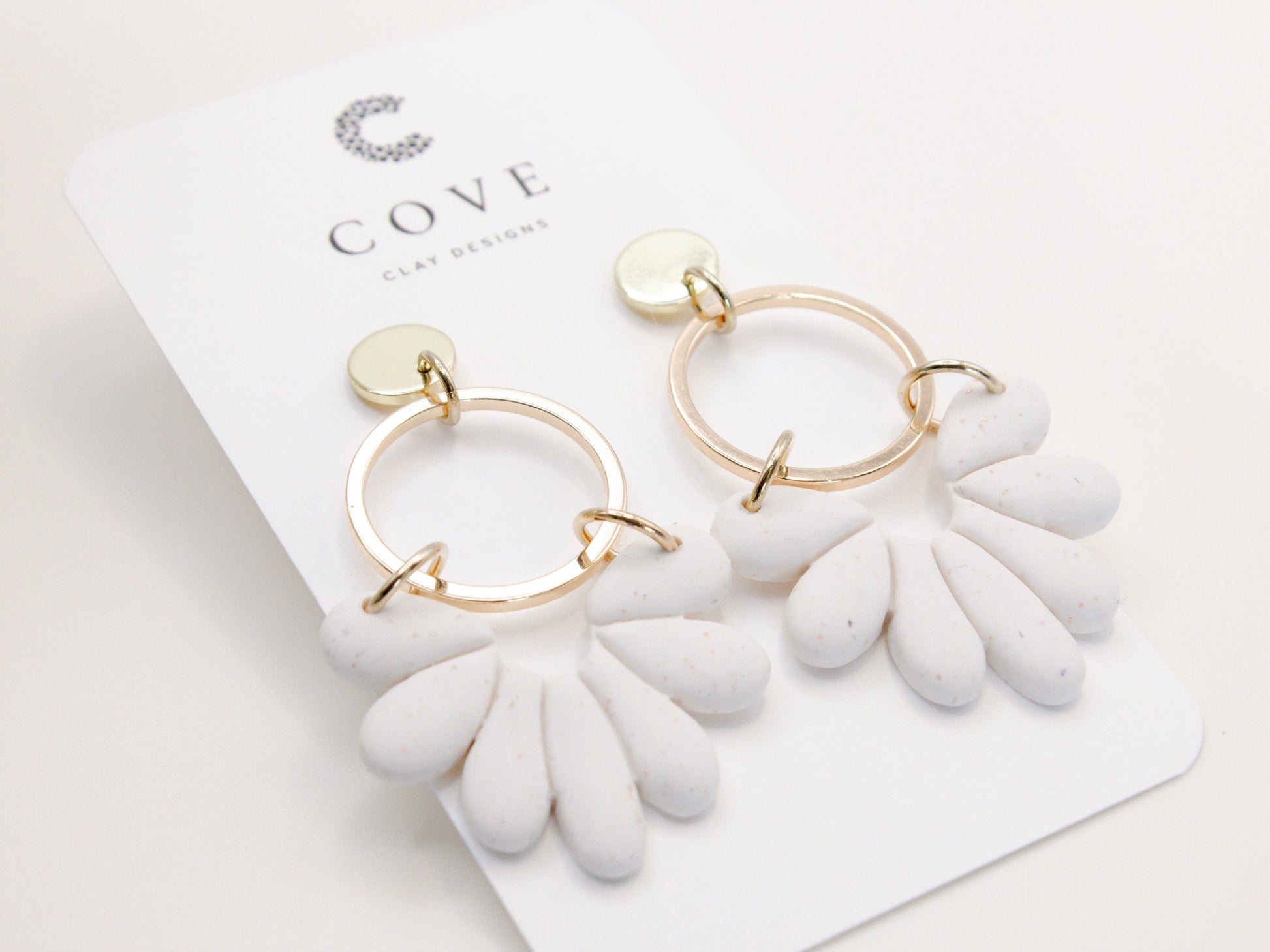 Handmade white sand effect scallop shell hoop dangle clay earrings with gold posts and round connectors by Cove Clay Designs