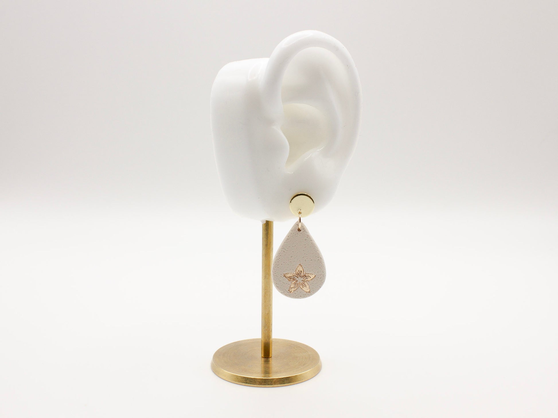 Handmade flower embossed teardrop clay earrings by Cove Clay Designs