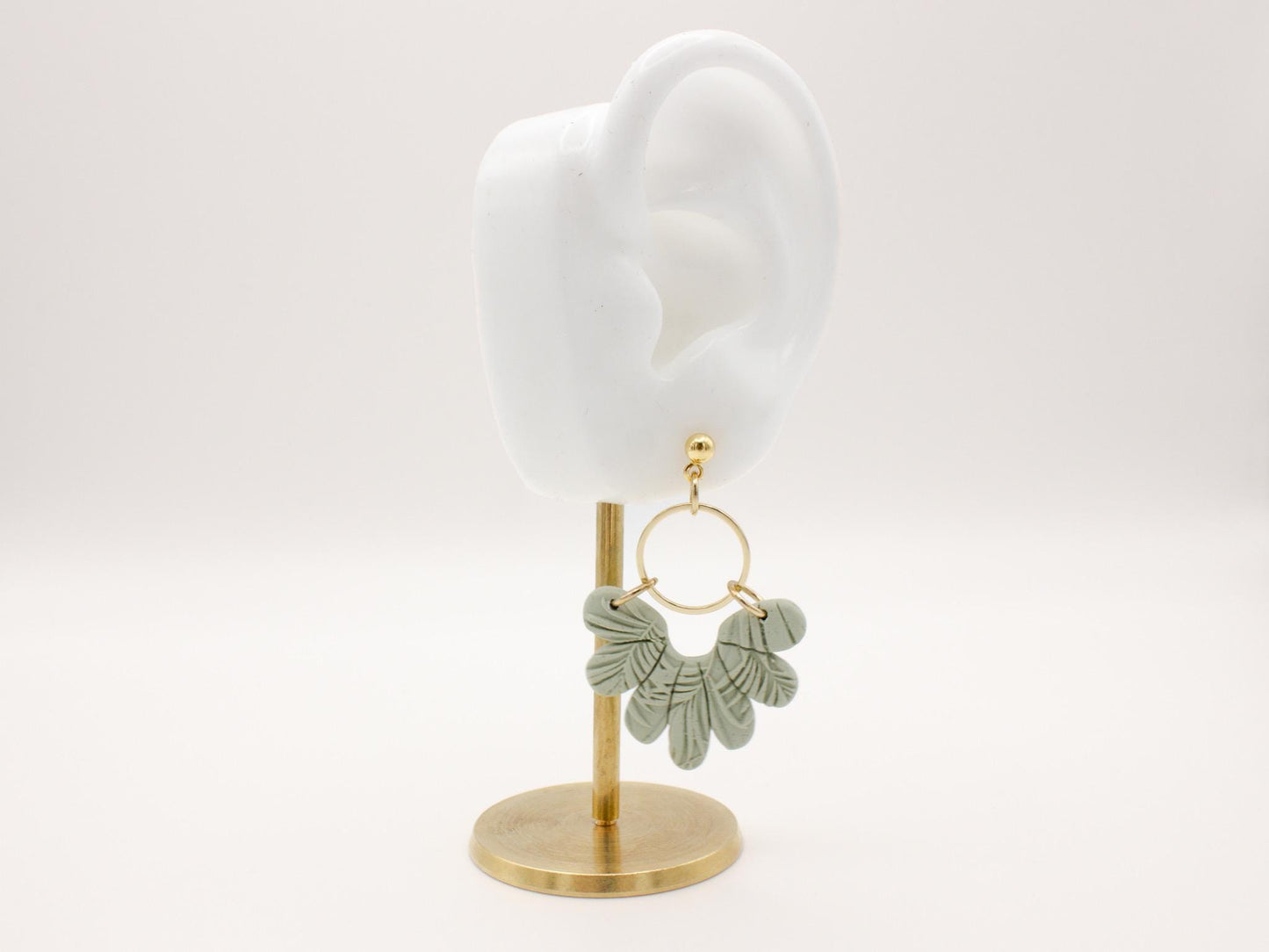 Handmade tropical green leaf polymer clay dangle earrings with gold hoop connectors by Cove Clay Designs