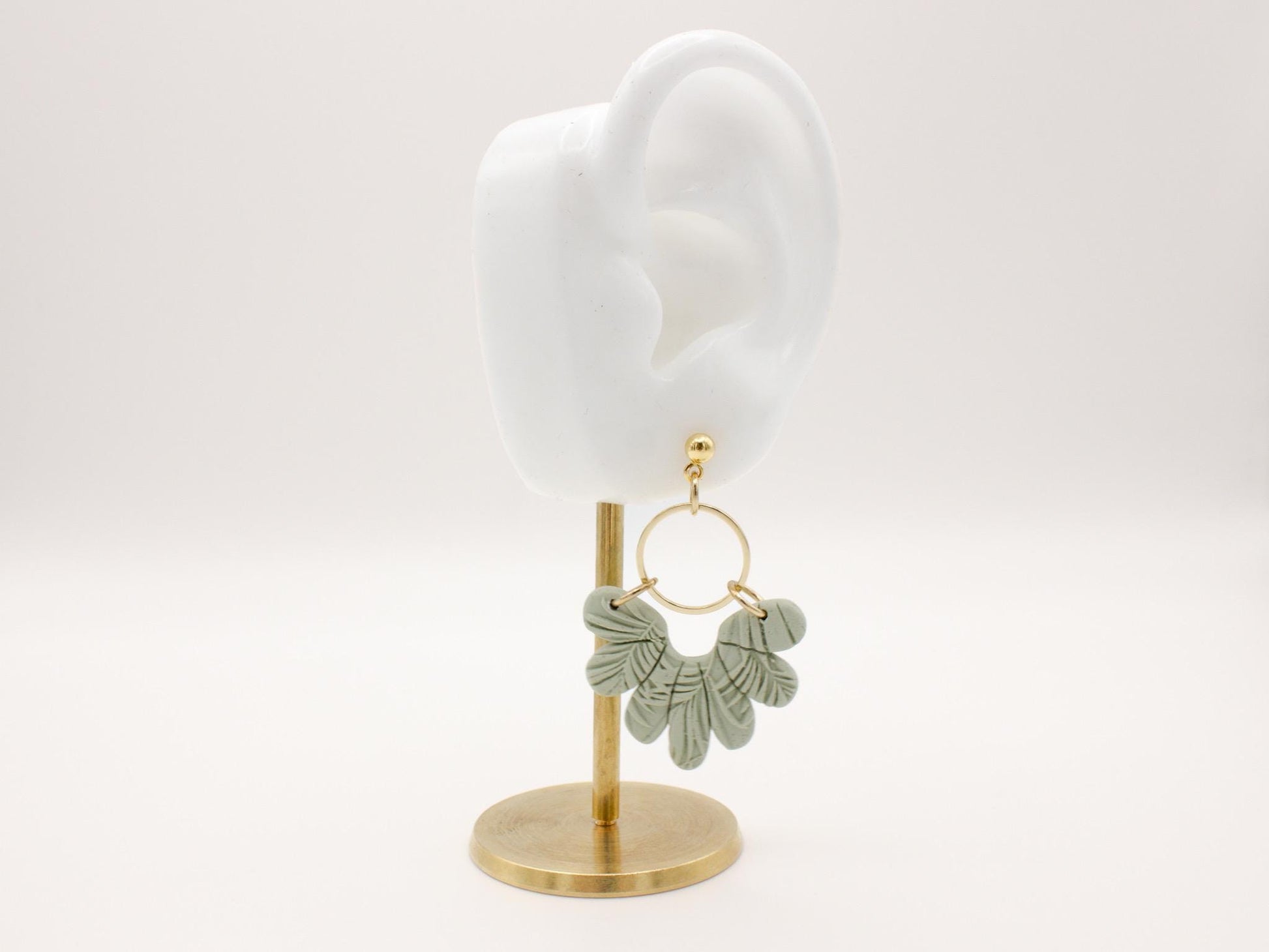 Handmade tropical green leaf polymer clay dangle earrings with gold hoop connectors by Cove Clay Designs