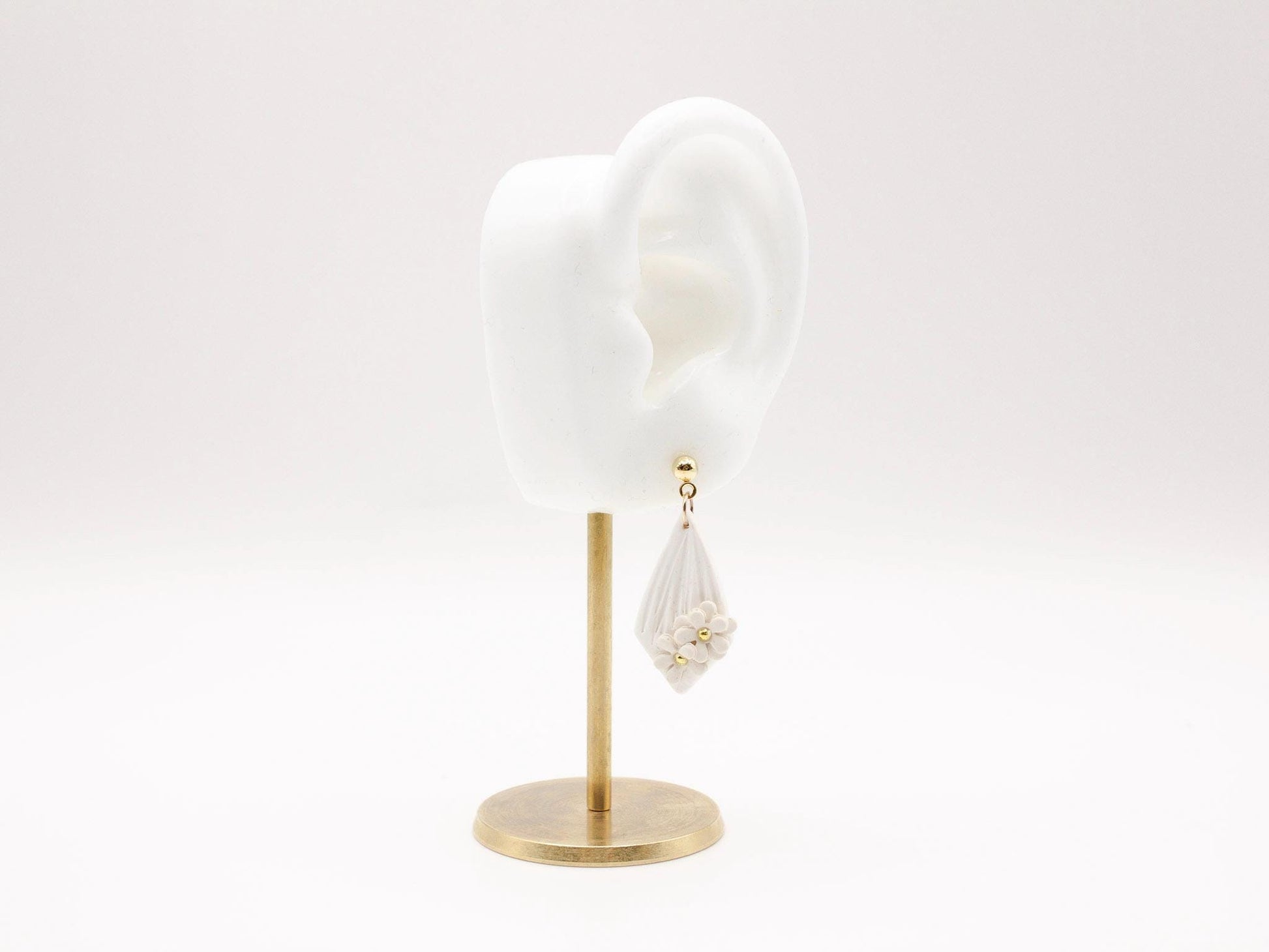 Handmade white diamond shaped polymer clay earrings with gold bar and mini flowers by Cove Clay Designs