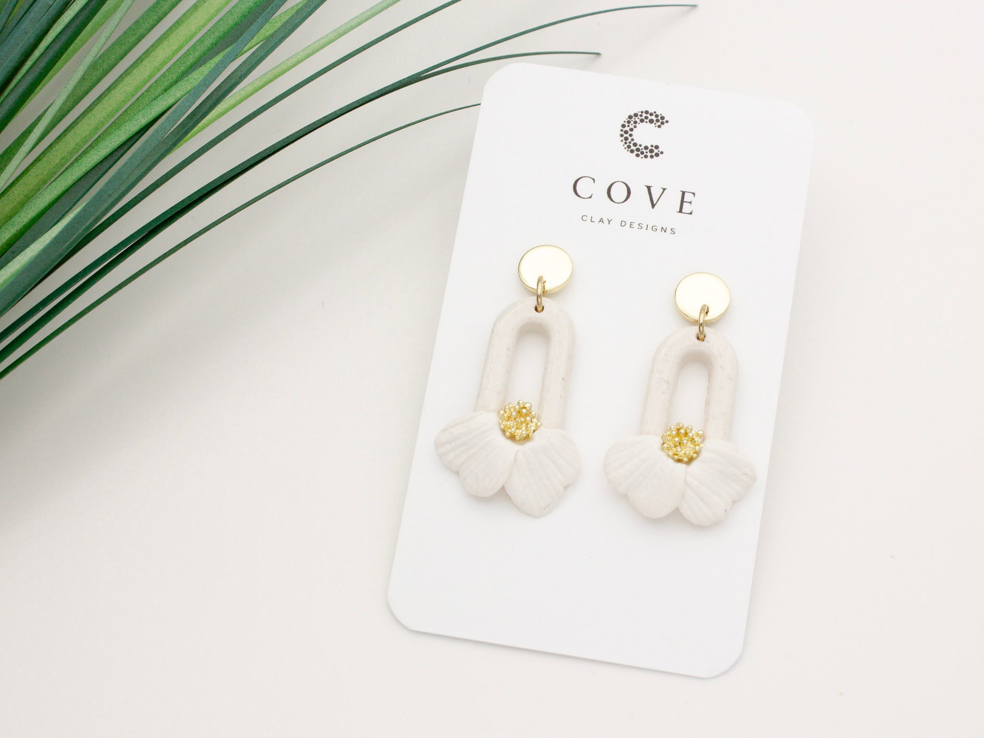 Handmade white flower petal hoop polymer clay earrings by Cove Clay Designs