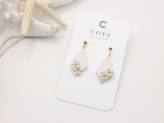 Handmade white diamond shaped polymer clay earrings with gold bar and mini flowers by Cove Clay Designs