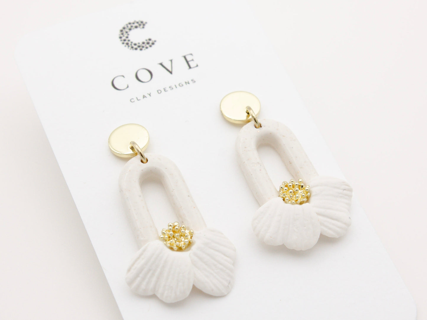 Handmade white flower petal hoop polymer clay earrings by Cove Clay Designs