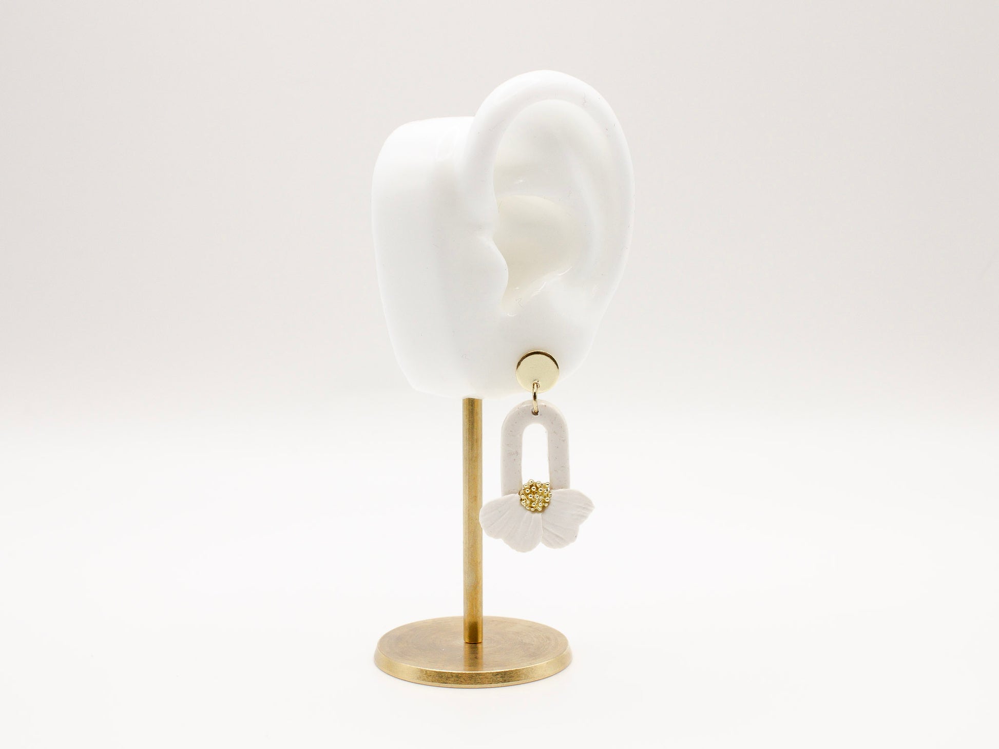 Handmade white flower petal hoop polymer clay earrings by Cove Clay Designs