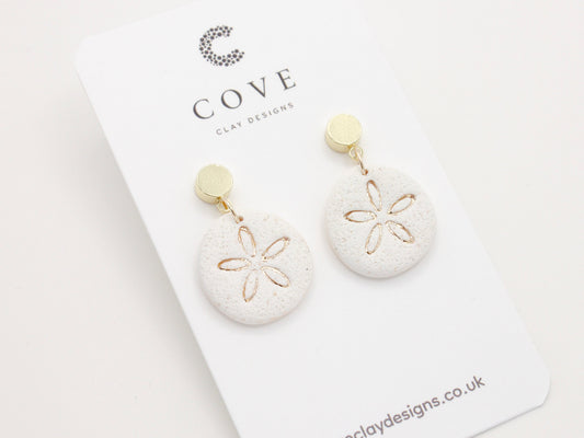 Handmade sand dollar polymer clay earrings with a delicate sand effect finish 