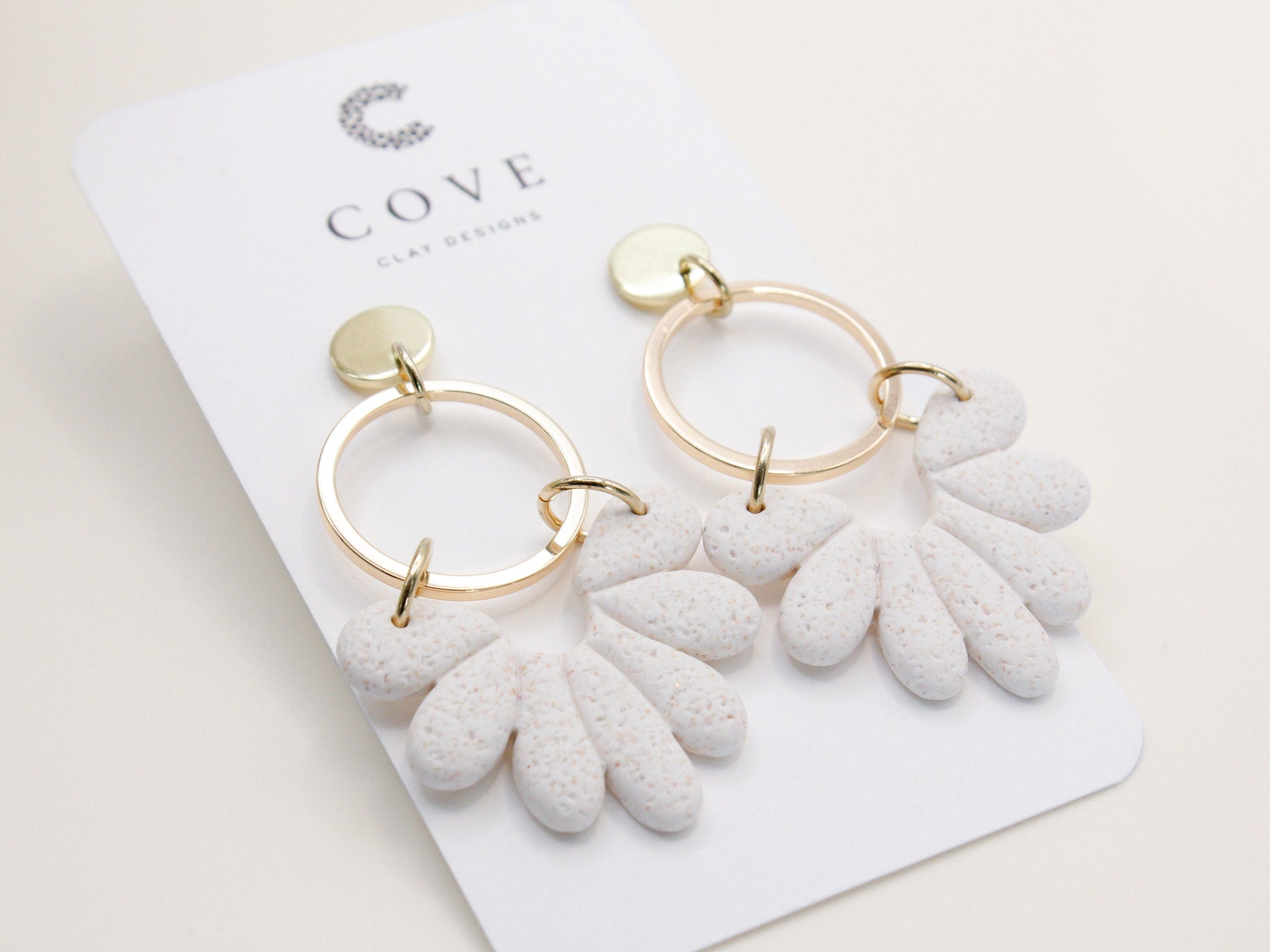 Handmade white sand effect scallop shell hoop dangle clay earrings with gold posts and round connectors by Cove Clay Designs