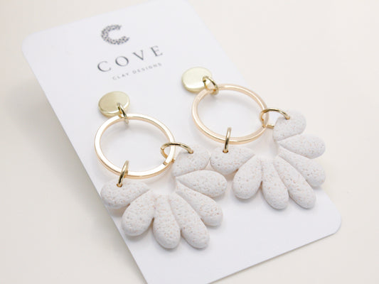 Handmade white sand effect scallop shell hoop dangle clay earrings with gold posts and round connectors by Cove Clay Designs