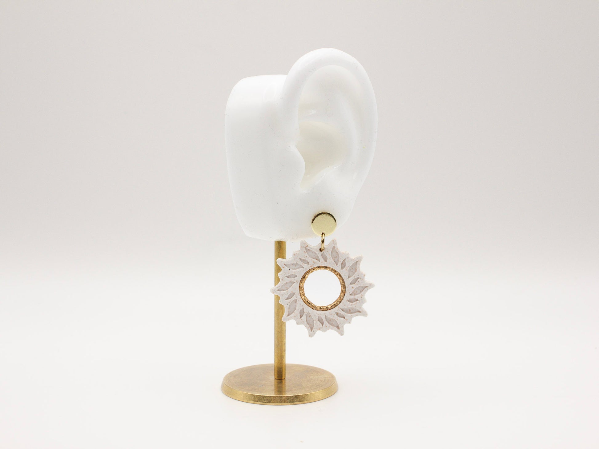 Handmade white sun dangle clay earrings with gold posts by Cove Clay Designs